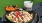 food and a drink on a table by a grassy area