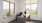 a room with a desk and windows