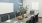 a conference table with a bowl of bagels next to a plant