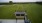 a building next to a green field