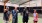 a group of people pose for a photo on a tennis court