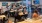 a group of people sitting at tables in a room with tvs